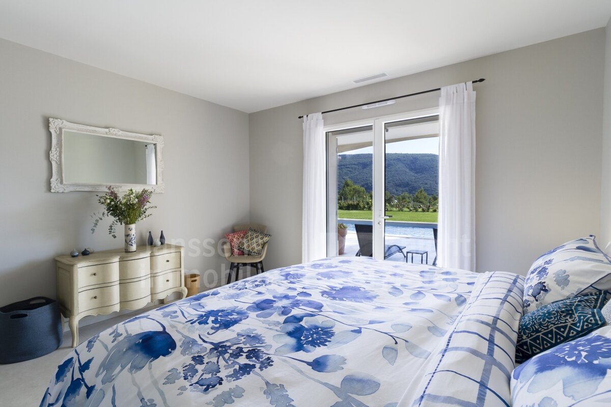 A bedroom with a blue and white floral comforter