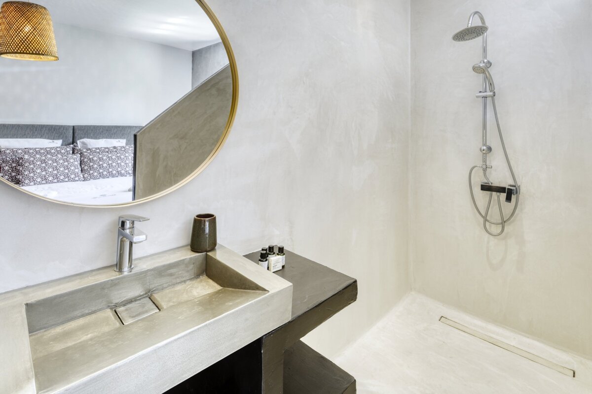 A bathroom with a sink a mirror and a shower