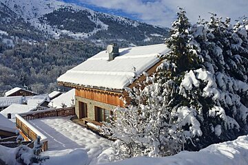 A snow covered roof of a house in the mountains
