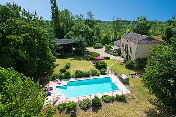 An aerial view of a large house with a swimming pool