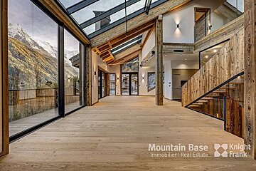 A large room with a lot of windows and a sign that says mountain base