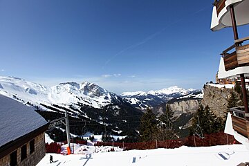 A view of a ski resort with mountains in the background