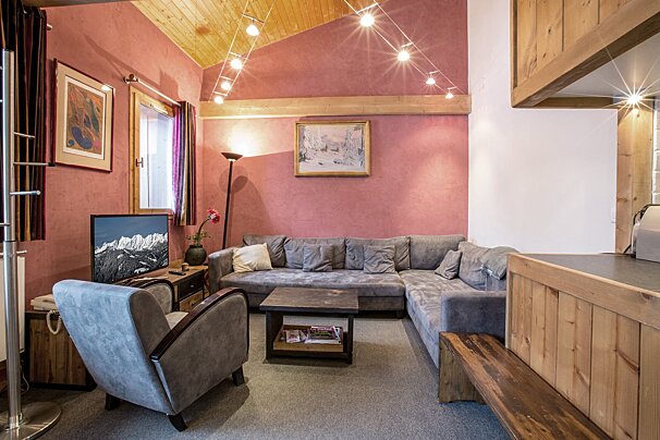 A living room with a couch a chair and a television