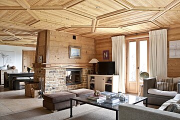 A living room with a fireplace and a flat screen tv