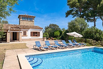 A house with a swimming pool in front of it
