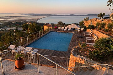 A large swimming pool with a view of the ocean