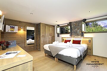 A bedroom with a bed and a mirror on the wall