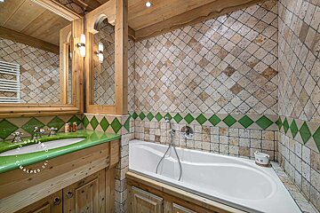 A bathroom with a green sink and a bathtub