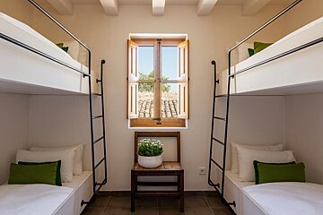 A small room with bunk beds and a window