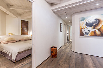 A bedroom with a painting of two polar bears on the wall