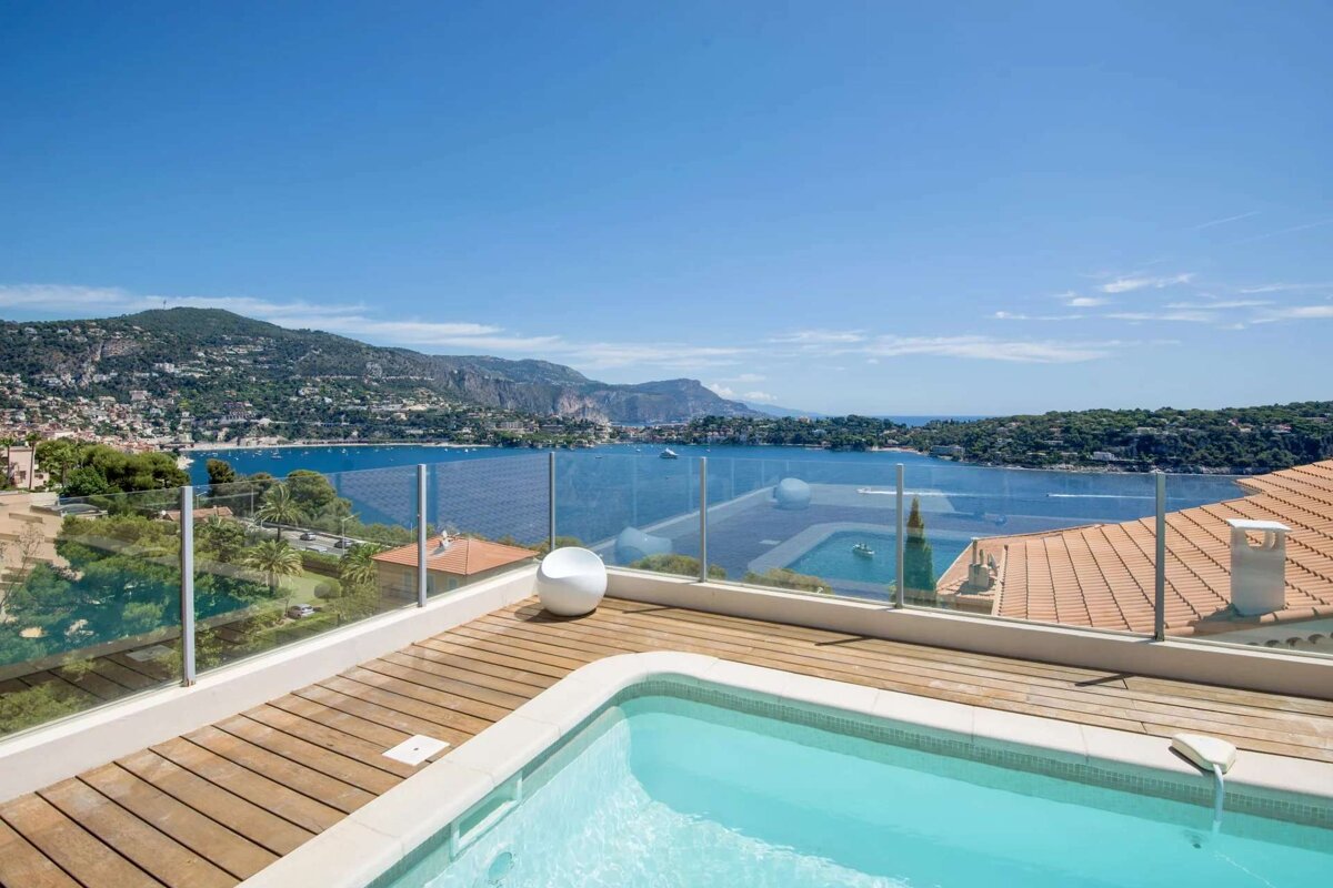 A swimming pool on a balcony overlooking a body of water