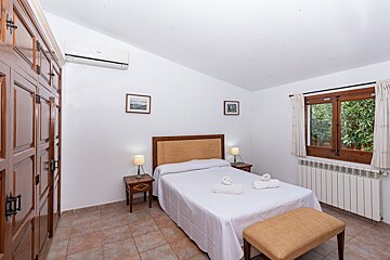 A bedroom with a large bed and a radiator