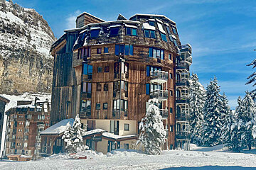 A snowy building with a sign that says ' hotel ' on it