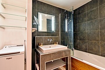 A bathroom with a sink and a whirlpool washer