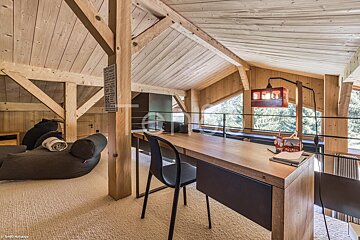 A room with a wooden table and chairs and a sign on the wall that says ' a ' on it