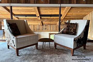 A living room with a cowhide rug on the floor
