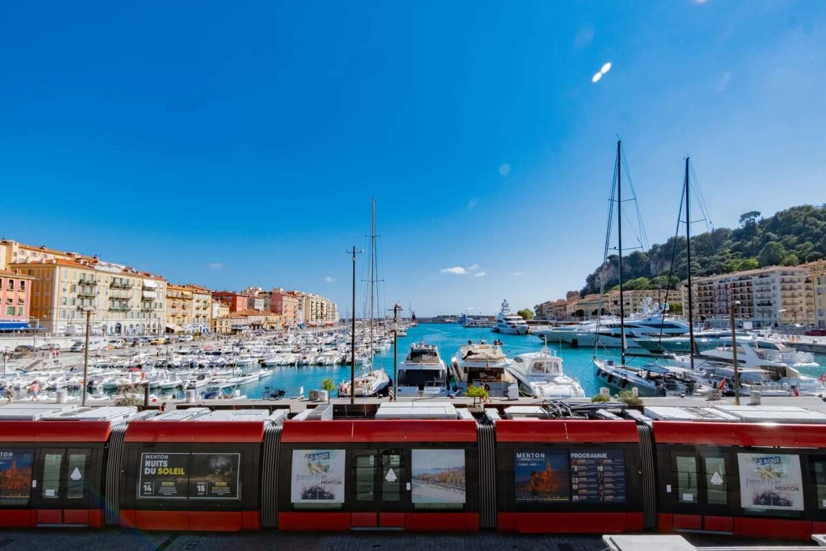 A row of boats in a harbor with a sign that says route du soleil