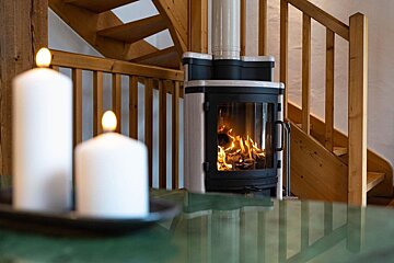 A fireplace with a staircase in the background