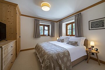 A bedroom with a bed and a picture on the wall