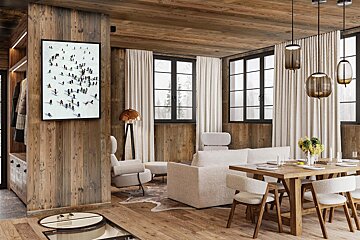 A living room with a picture of skiers on the wall
