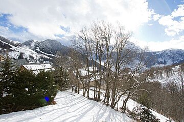 A snowy landscape with mountains in the background