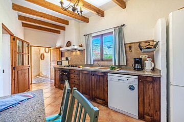 A kitchen with a dishwasher and a coffee maker