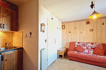 A room with a couch and a clock on the wall