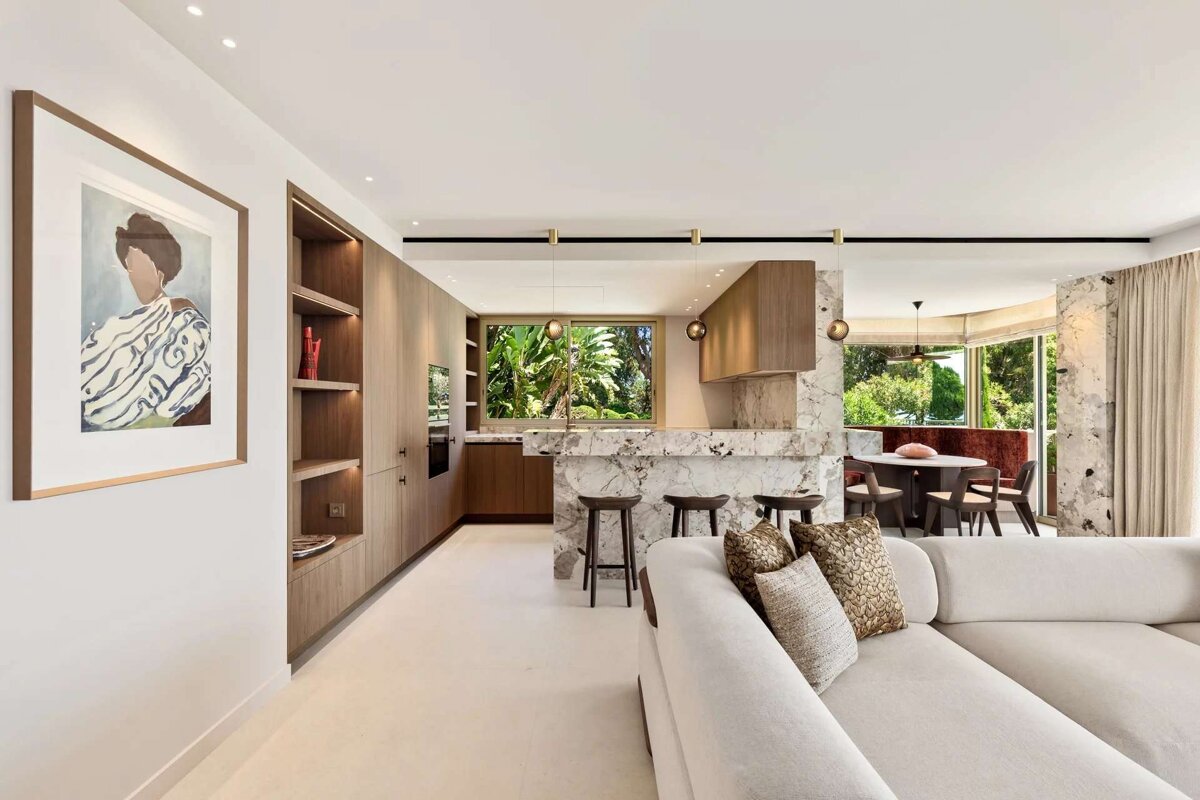 A living room with a couch and a painting on the wall