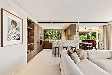 A living room with a couch and a painting on the wall