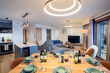 A table set for a meal with a bottle of wine that says ' bordeaux ' on it