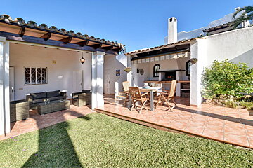 A patio with a table and chairs and a couch