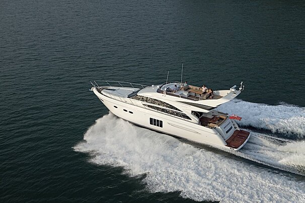 A large white yacht is floating on top of a body of water