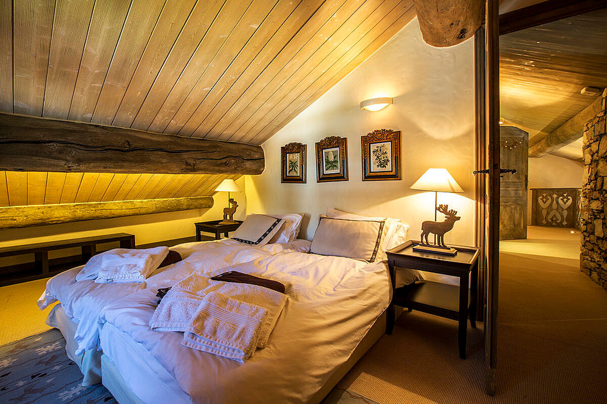 A bedroom with two beds and a lamp with a deer on it