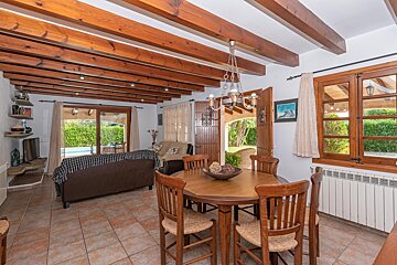 A living room with a table and chairs and a picture on the wall