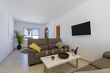 A living room with a couch and a flat screen tv