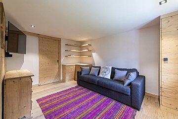 A living room with a couch and a television