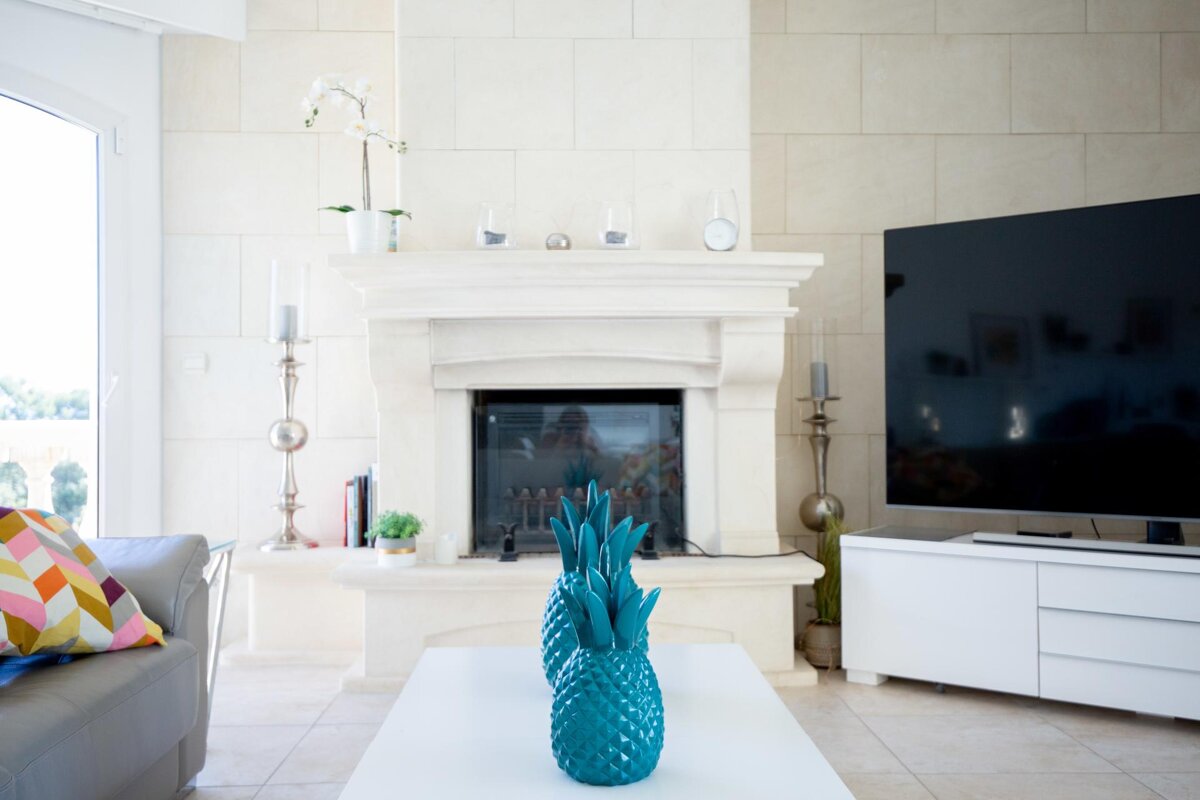 A living room with a fireplace and a flat screen tv