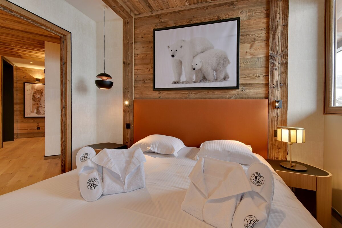 A bedroom with a picture of polar bears on the wall