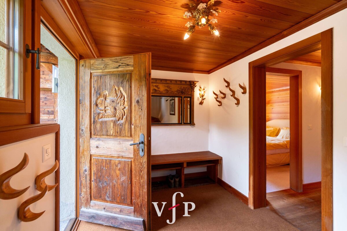 A hallway with a wooden door and a sign that says vjp