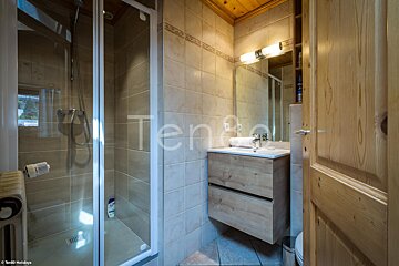 A bathroom with a sink and a shower with the word ten on the wall