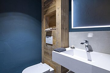 A bathroom with blue walls and a white sink