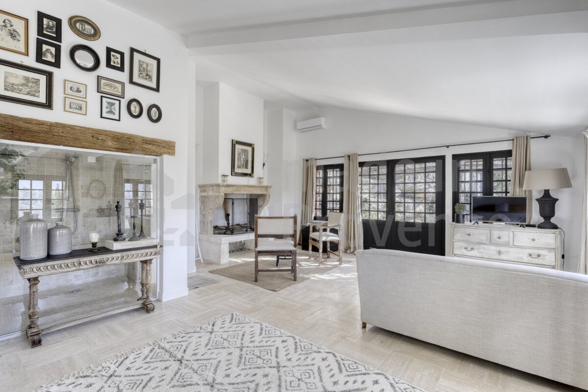 A living room with a fireplace and pictures on the wall