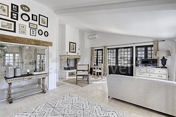 A living room with a fireplace and pictures on the wall