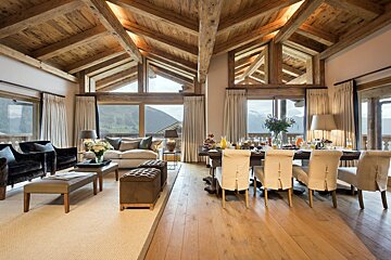A living room with a dining table and chairs