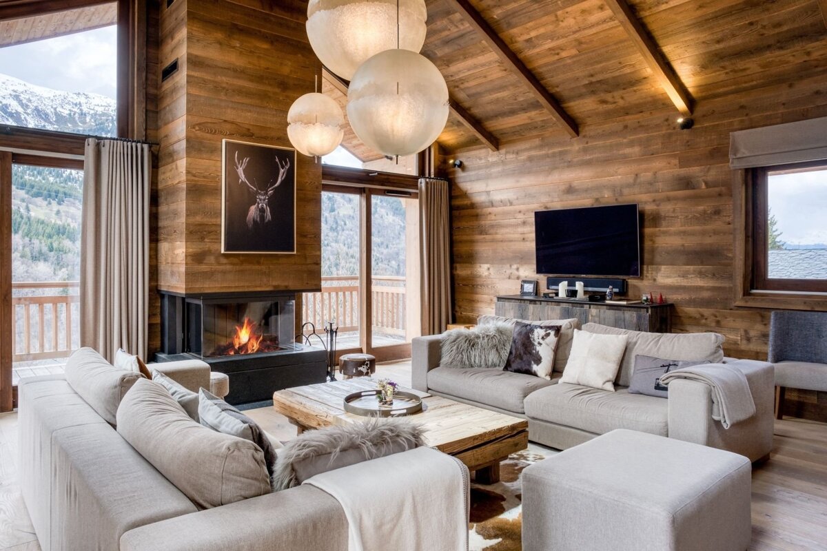 A living room with a fireplace and a picture of a deer on the wall