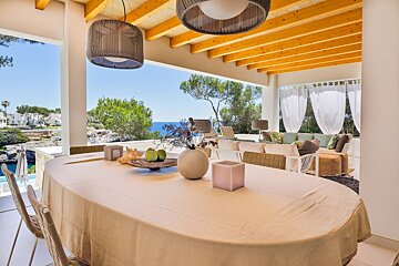 A dining room table with a white table cloth