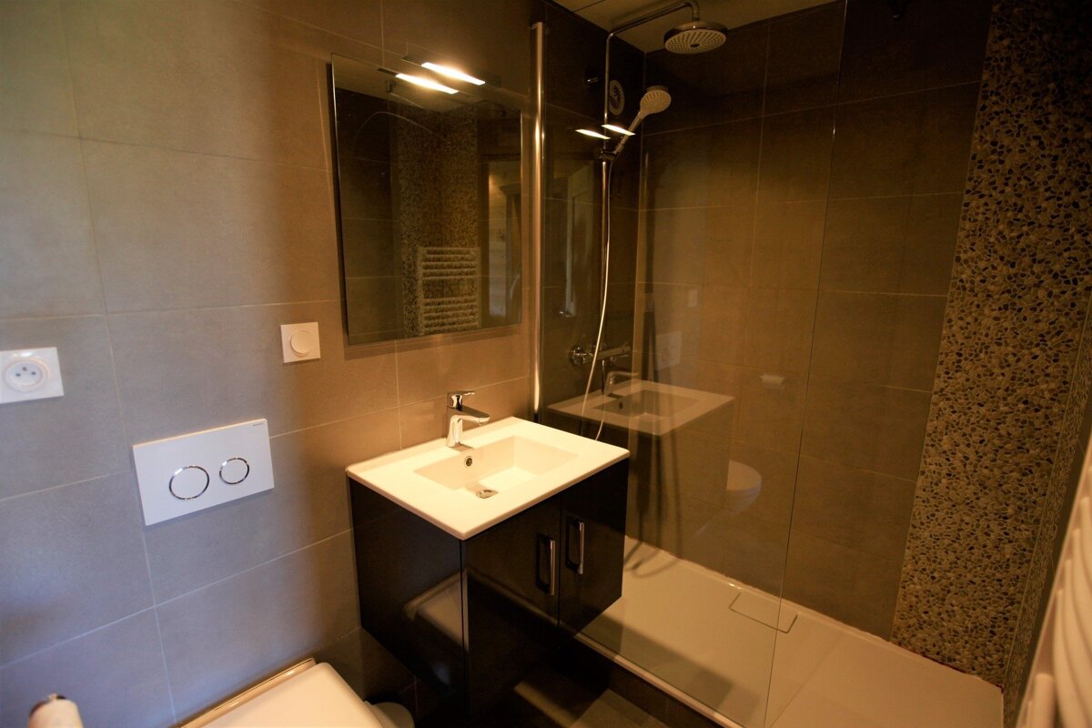 A bathroom with a toilet sink and a shower