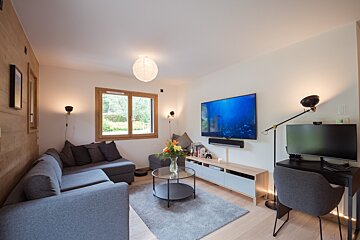 A living room with a couch and a flat screen tv