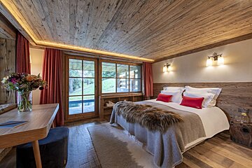 A bedroom with a large bed and a window
