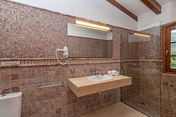 A bathroom with a toilet a sink and a mirror